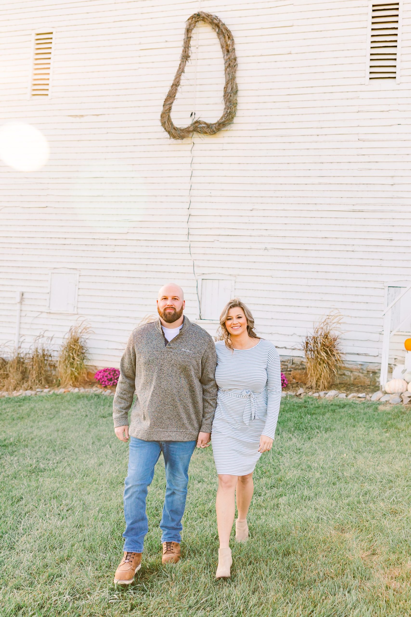 engaged couple in front of barn